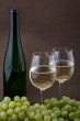 White wine with bottle, glasses and grapes