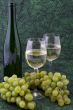 White wine with bottle, glasses and grapes