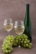 White wine with bottle, glasses and grapes