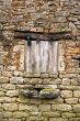 Old yellow stone wall with close window - 2