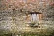 Old yellow stone wall with close window - 3