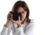 young woman with old camera isolated on white background