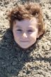Child buried in the sand