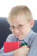 Boy in eyeglasses embrace three interesting books