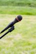 Microphone on air over green grass at background