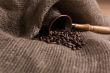 Cezve with freshly roasted coffee beans on sackcloth