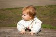 Small girl sits on the bench