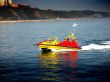 powerboat along the coast on a sunny day