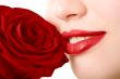 Close-up of beautiful girl with red rose