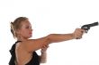 young blond woman in black dress with revolver isolated on white background