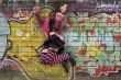 Teenager jumps before graffiti wall