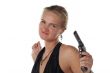 young blond woman in black dress with revolver isolated on white background