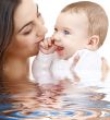 bathing baby in mother hands