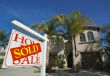 Sold Home For Sale Sign & New House