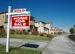 Sold Home For Sale Sign & New House