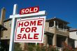 Sold Home For Sale Sign & New House