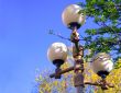 Street lamp among green foliage