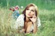 beautiful girl lying down of grass