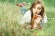 beautiful girl lying down of grass