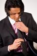 Young man bounding his necktie