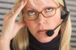 Businesswoman with Phone Headset and Headache