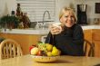 Woman In Kitchen with Cup of Coffee
