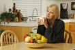 Woman in Kitchen with Cup of Coffee
