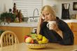 Woman Holding Head in Kitchen