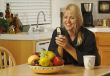 Woman In Kitchen Using Cell Phone
