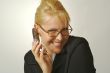 Elated Businesswoman Smiles While Using Her Cell Phone