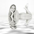 Lying down naked by the water