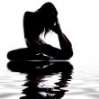 Silhouette of a gymnast in the water