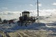 Grader removing snow