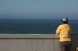 Bicyclist Rests Near Ocean