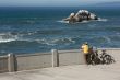 Bicyclist Rests Near Ocean