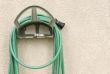Garden Hose Hanging on Stucco Wall
