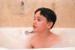 kid in a bathtub with foam