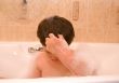 kid in a bathtub with foam