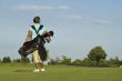 Woman Golfer Carrying Golf Clubs