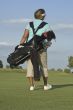 Woman Golfer Carrying Golf Bag