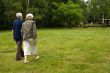 Older couple walking through a park