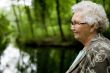 Grandmother standing near a stream