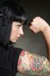 woman with tattoo and fist