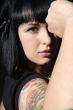 woman with tattoo and fist