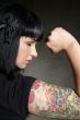 woman with tattoo and fist