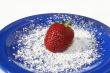 Single strawberry on plate
