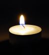 Burning candle in darkness
