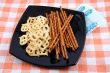 Crackers and salty sticks to beer and money