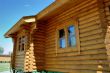 Wall of a wooden house with windows.