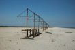 Wild or abandoned beach with old rusty sunshades